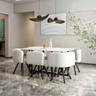 Modern dining room with a white table and chairs, abstract art on the wall, and decorative elements.