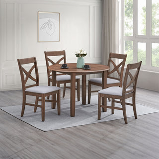 Dining room set with round wooden table and four chairs on a gray rug.